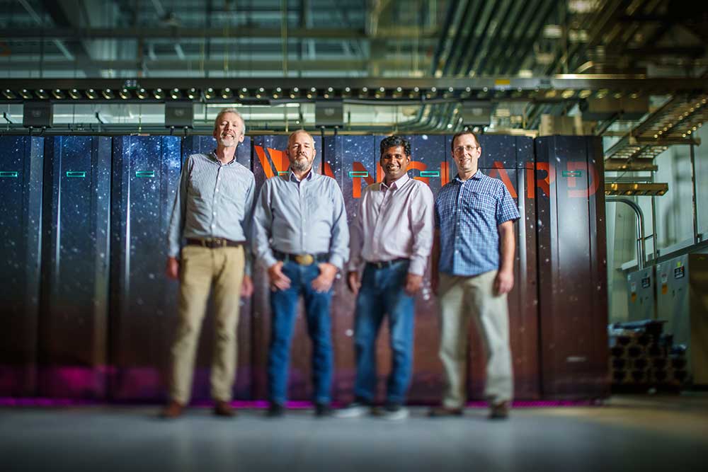 From left, Aidan Thompson, James Laros, Sivasankaran Rajamanickam and Stan Moore, posing in front of Vanguard’s Astra supercomputer.