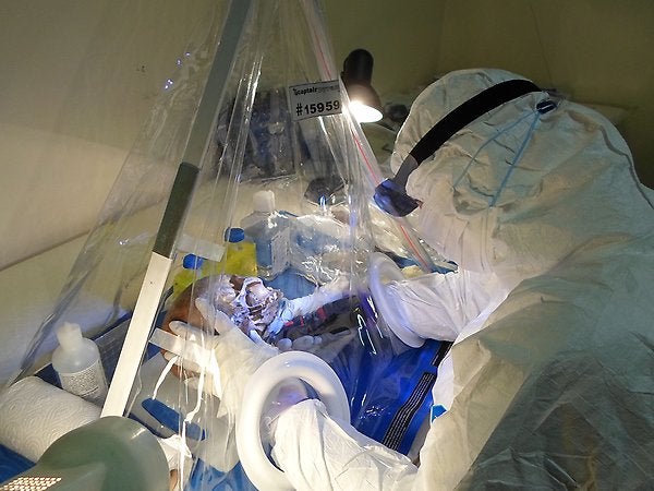Helena Malmström, researcher at the Department of Organismal Biology, sampling at the Florisbad research station using the mobile clean lab.