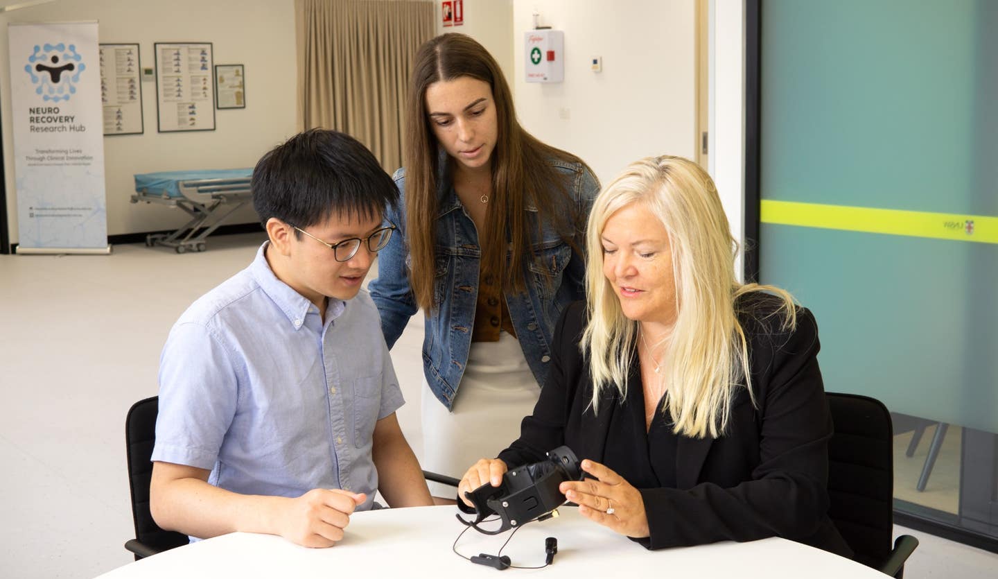 From left: Software engineer Kevin Yi Chen and PhD candidate Lara Alexander, members of the multidisciplinary PainWaive team, speak with Prof. Sylvia Gustin.