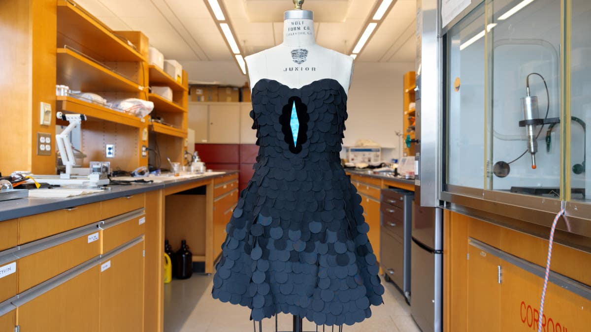 A dress designed by Zoe Alvarez ’25, a fashion design major, and inspired by the magnificent riflebird, uses the ultra-black material (the dots nearest the blue) and other deep-black fabrics. The ultrablack fabric created in the Responsive Apparel Design Lab is the darkest fabric currently reported.