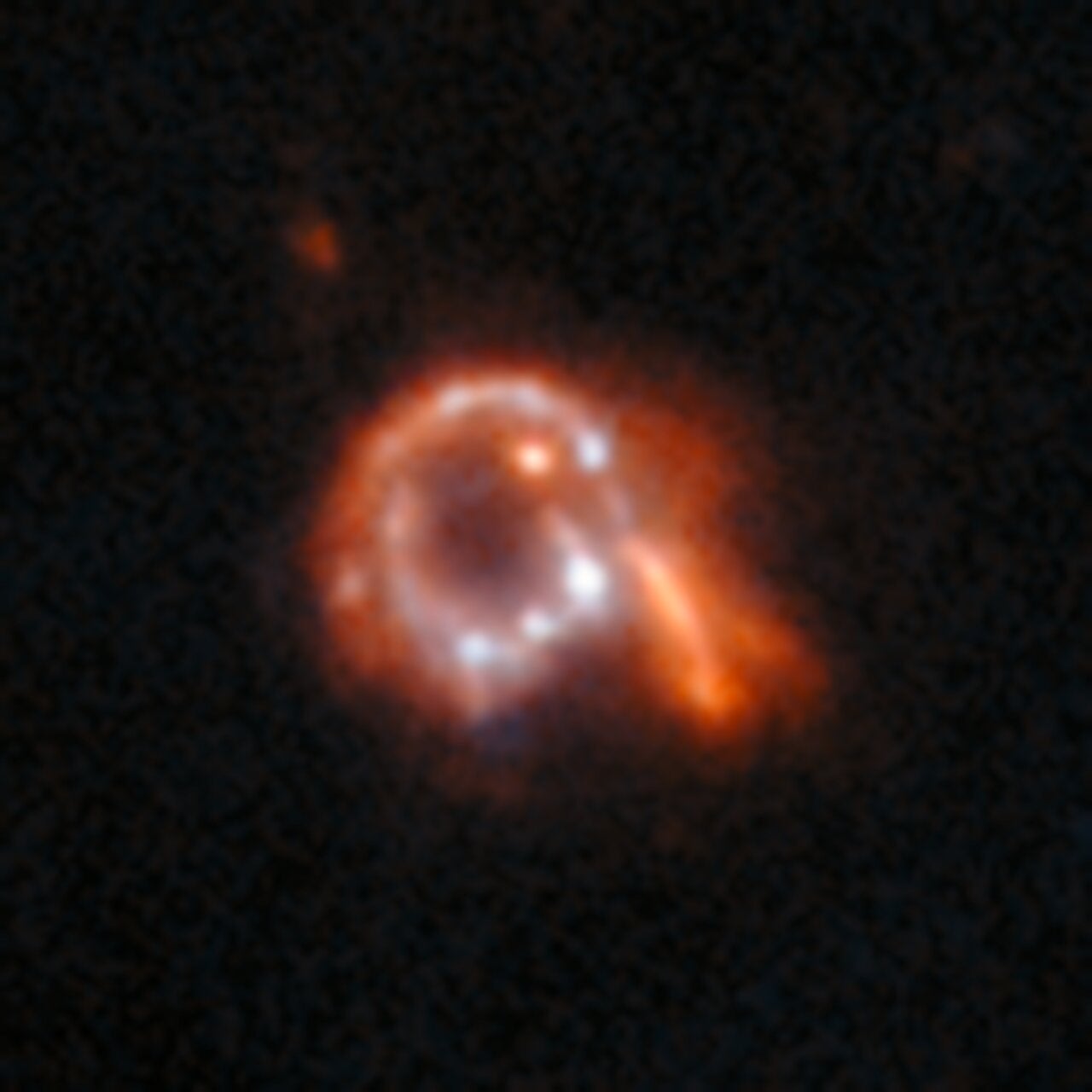 This object was classified by the research team as a “collisional ring” galaxy — one of only two that were found. These are galaxies which are partly or wholly ring-shaped, but with a disrupted or bent disc that is noticeably luminous. These ring formations arise when a galaxy collides with another by crashing right through its centre, creating a roiling, circular wave of star formation.