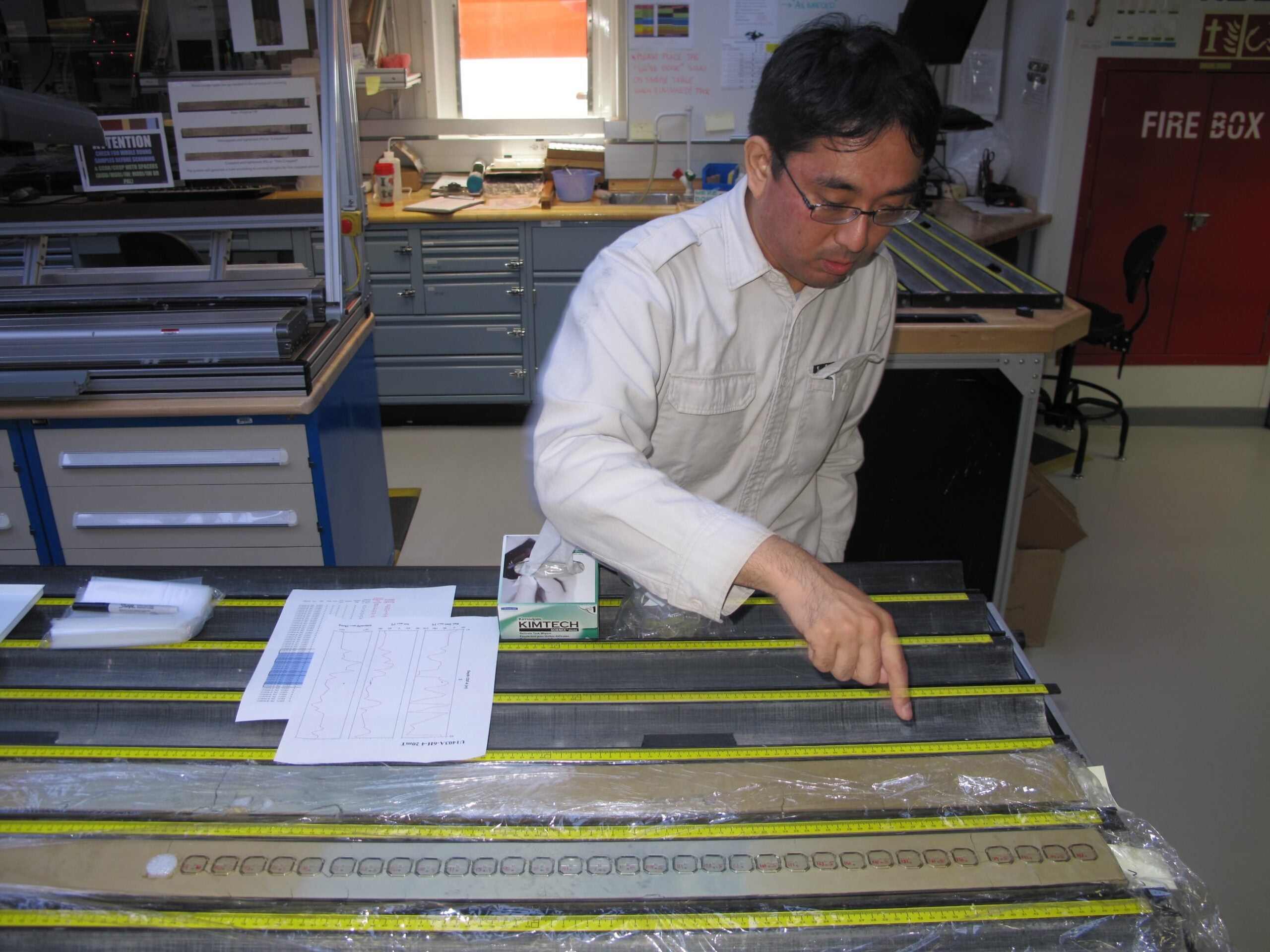 Yuhji Yamamoto examines drilling cores on the JOIDES Resolution during the 2012 expedition in the North Atlantic.