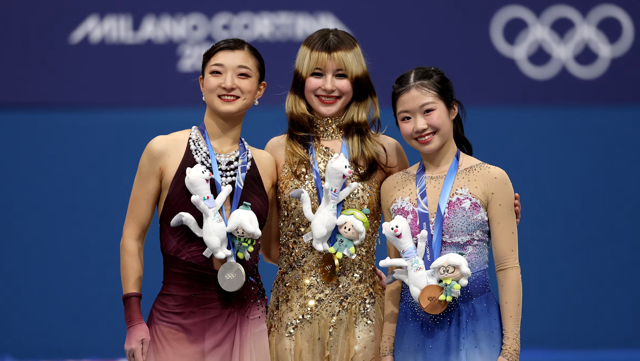 Gold medallist Alysa Liu of the United States, flanked by silver medallist Sakamoto Kaori (left) and bronze medalist Nakai Ami (right), both from Japan, on the podium after the women’s singles competition at the Olympic Winter Games Milano Cortina 2026 on February 19, 2026.