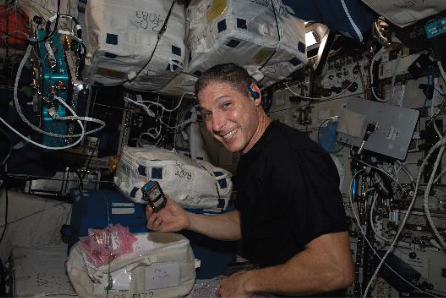 The BioAsteroid experiment. NASA astronaut Michael Scott Hopkins performs the insertion of the experiment containers in KUBIK.