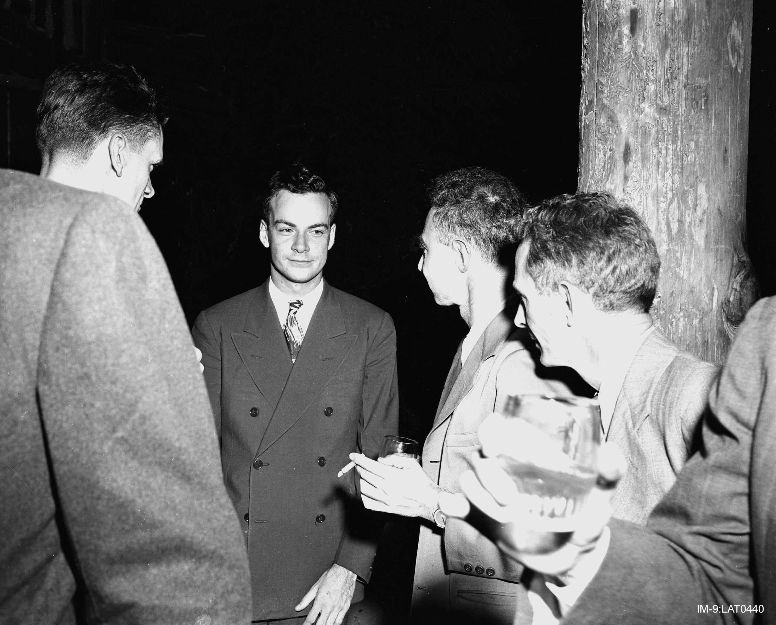 Feynman (center) with Robert Oppenheimer (immediately right of Feynman) at a Los Alamos Laboratory social function during the Manhattan Project. 