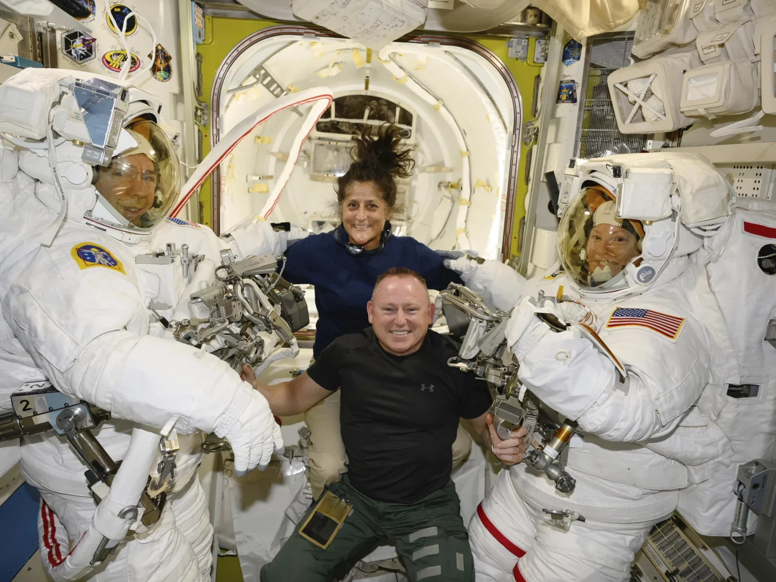 Boeing crew flight test astronauts Suni Williams and Butch Wilmore, center, pose with Expedition 71 flight engineers Mike Barratt, left, and Tracy Dyson, both NASA astronauts