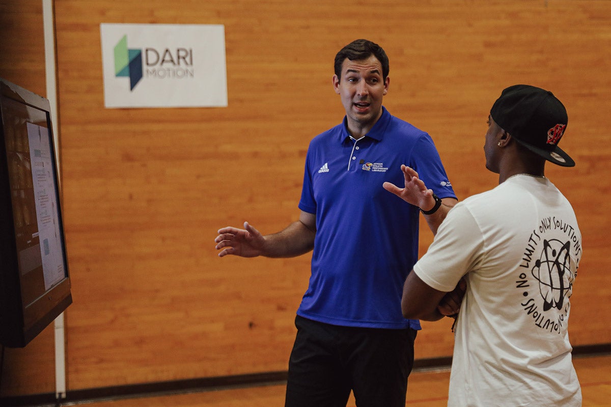 Dimitrije Cabarkapa, left, of the Jayhawk Athletic Performance Laboratory discusses motion capture analysis with Cornell Jenkins. The two are part of a project to analyze shooting form to help coaches and players improve mechanics and will attempt a world record for most consecutive made three-point shots. 