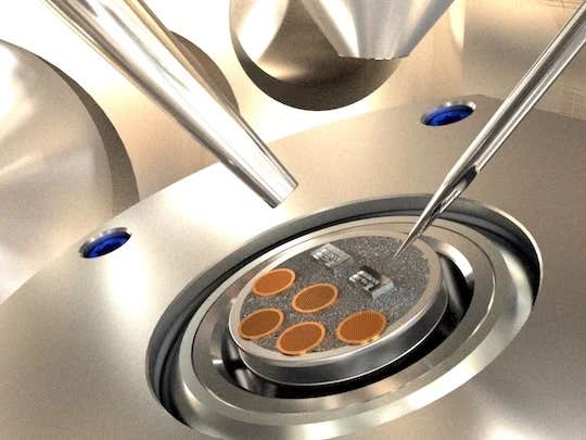 Close-up view of the top of the sample transfer box (top door open), showing that the lithium dendrite was transferred using a micromanipulator tip (a sharp silver needle) from the brown copper transmission electron microscopy grids to the Rice micromechanical devices (silver blocks), ready for subsequent testing and characterization.