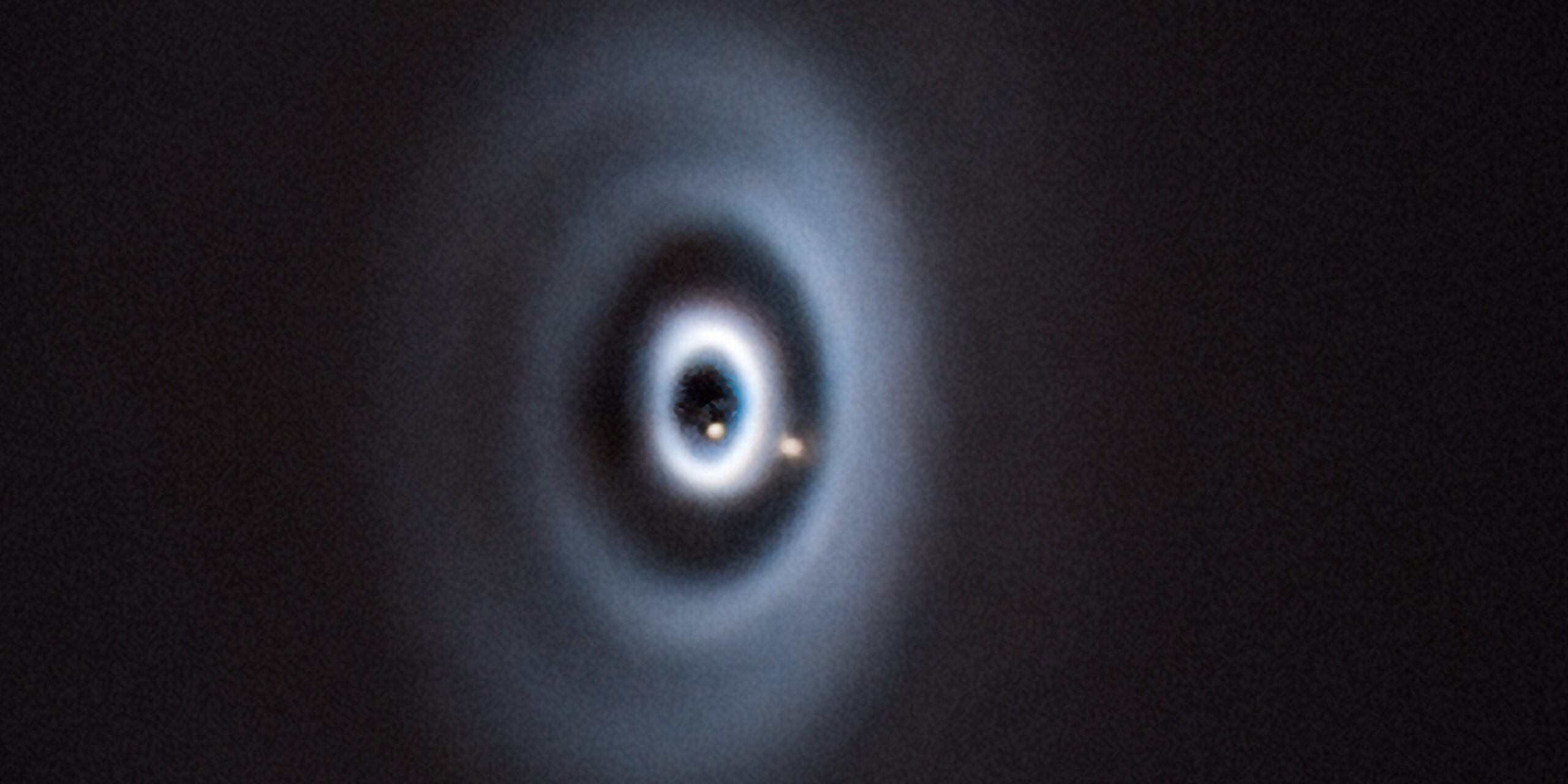 This is roughly what the formation of the Earth in our solar system might have looked like. The birth of two planets (light brown dots) in a protoplanetary disc around the young star WISPIT 2.