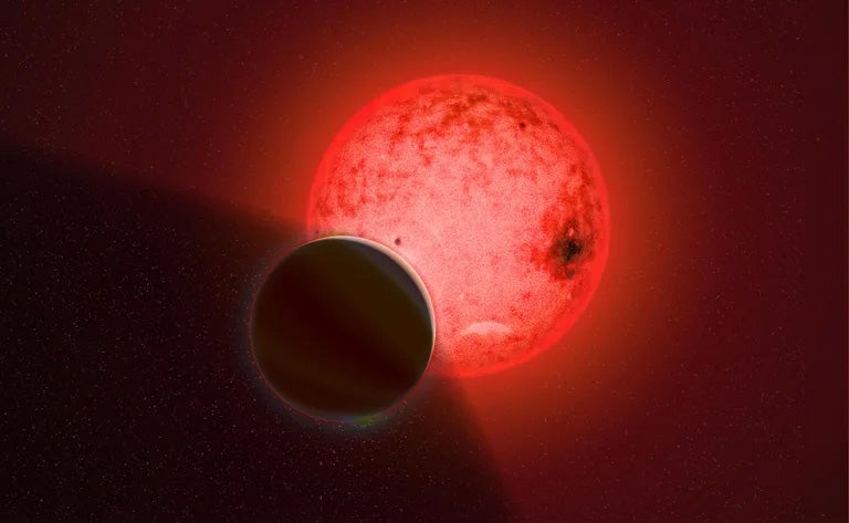 Artist's conception of a large gas giant planet orbiting a small red dwarf star called TOI-5205.