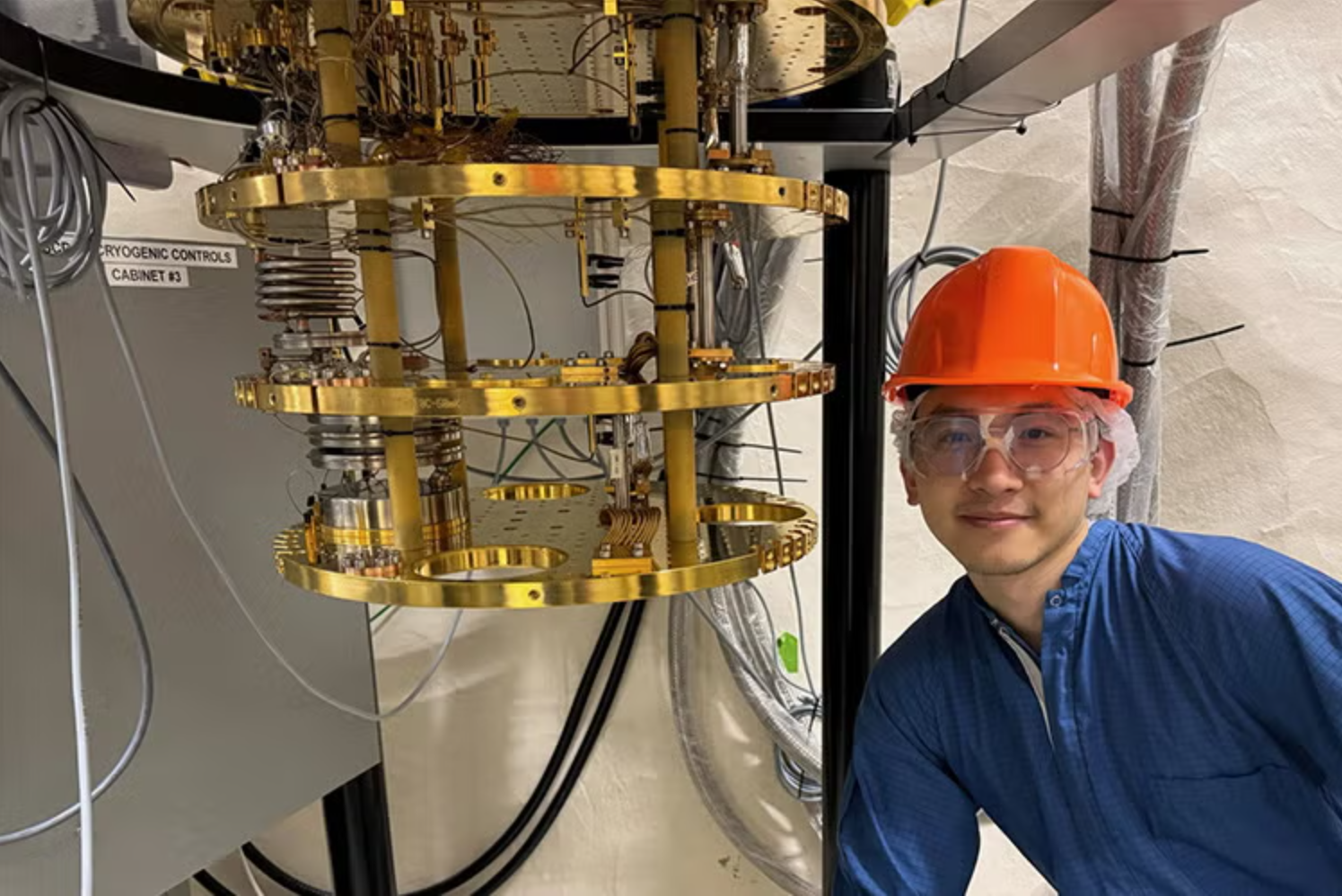 U of T graduate student Weigeng Peng with the SuperCDMS ‘refrigerator’ that got to within 1/50th of a degree Kevin above absolute zero.
