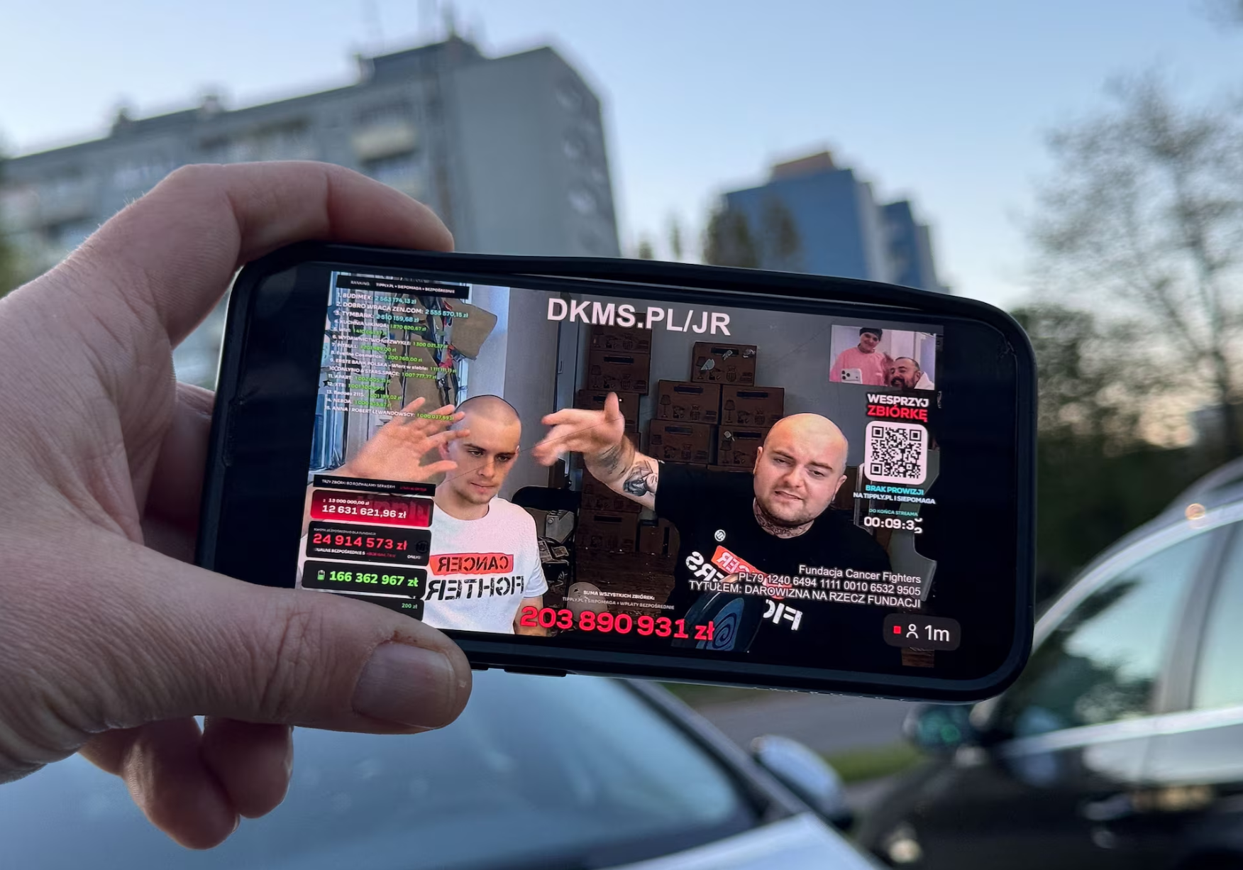 Polish influencer Piotr Hancke ‘Latwogang’,with rapper Bedoes 2115 (Borys Przybylski), are seen on the mobile screen during their nine-day livestream fundraiser, for cancer patients, in Warsaw, Poland, April 26, 2026. 