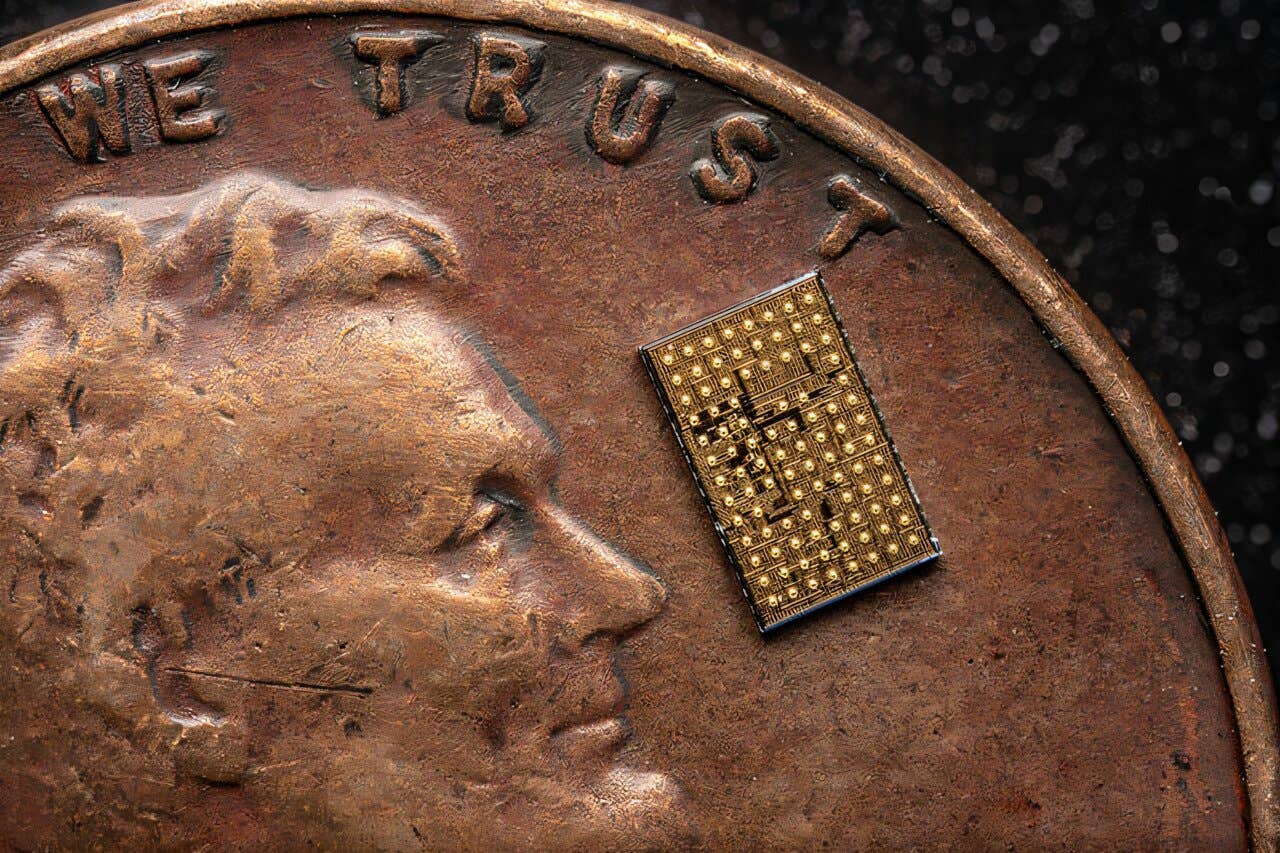 The new DC-DC step-down conversion chip shown on a U.S. penny for scale.