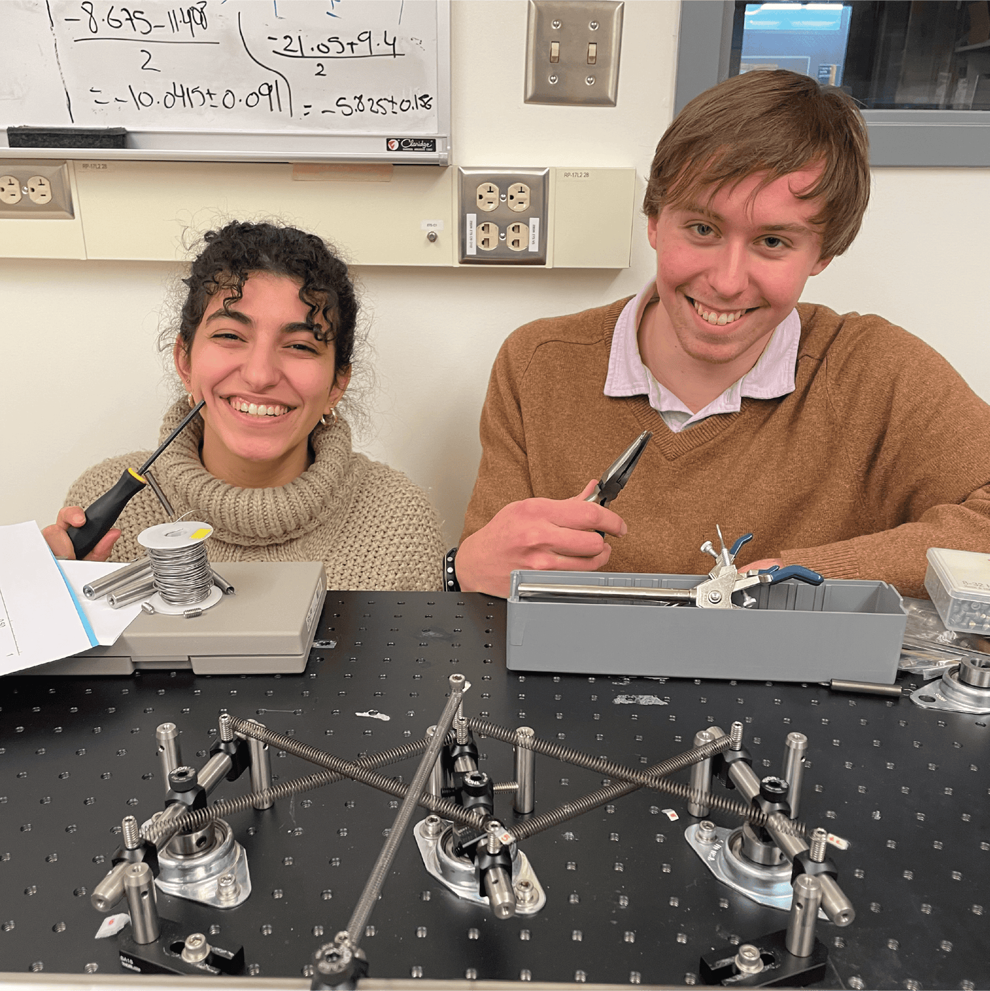 Led by Professor Paulsen (center), the St. Olaf undergraduate research team was composed of Faten Abu Al Ardat ’27, Harry Maakestad ’26, Alex Walk ’28, and Jack Feider ’26. St. Olaf College students Faten Abu Al Ardat ‘27 and Harry Maakestad ‘26 work on building the mechanical computer.