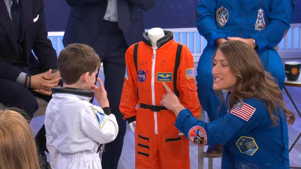 Artemis II mission specialist Christina Koch gives 5-year-old Jack a spacesuit during a CBS News town hall on May 1, 2026.
