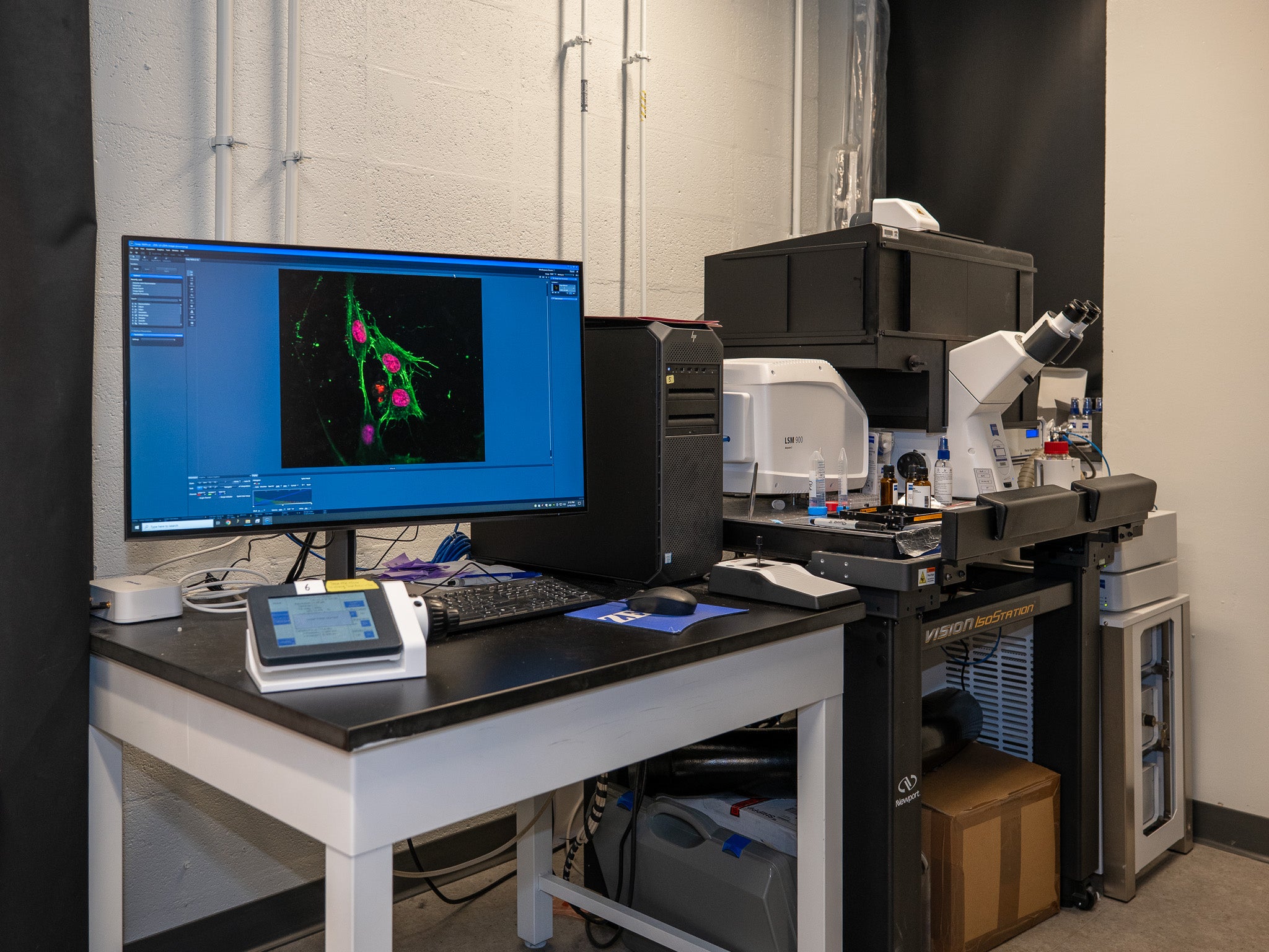 Thanks to the power of mollifier layers, the Shenoy Lab can now infer the hidden factors that drive complex processes like the folding of chromatin.  The monitor shows a sample of chromatin imaged using the microscope at right. 