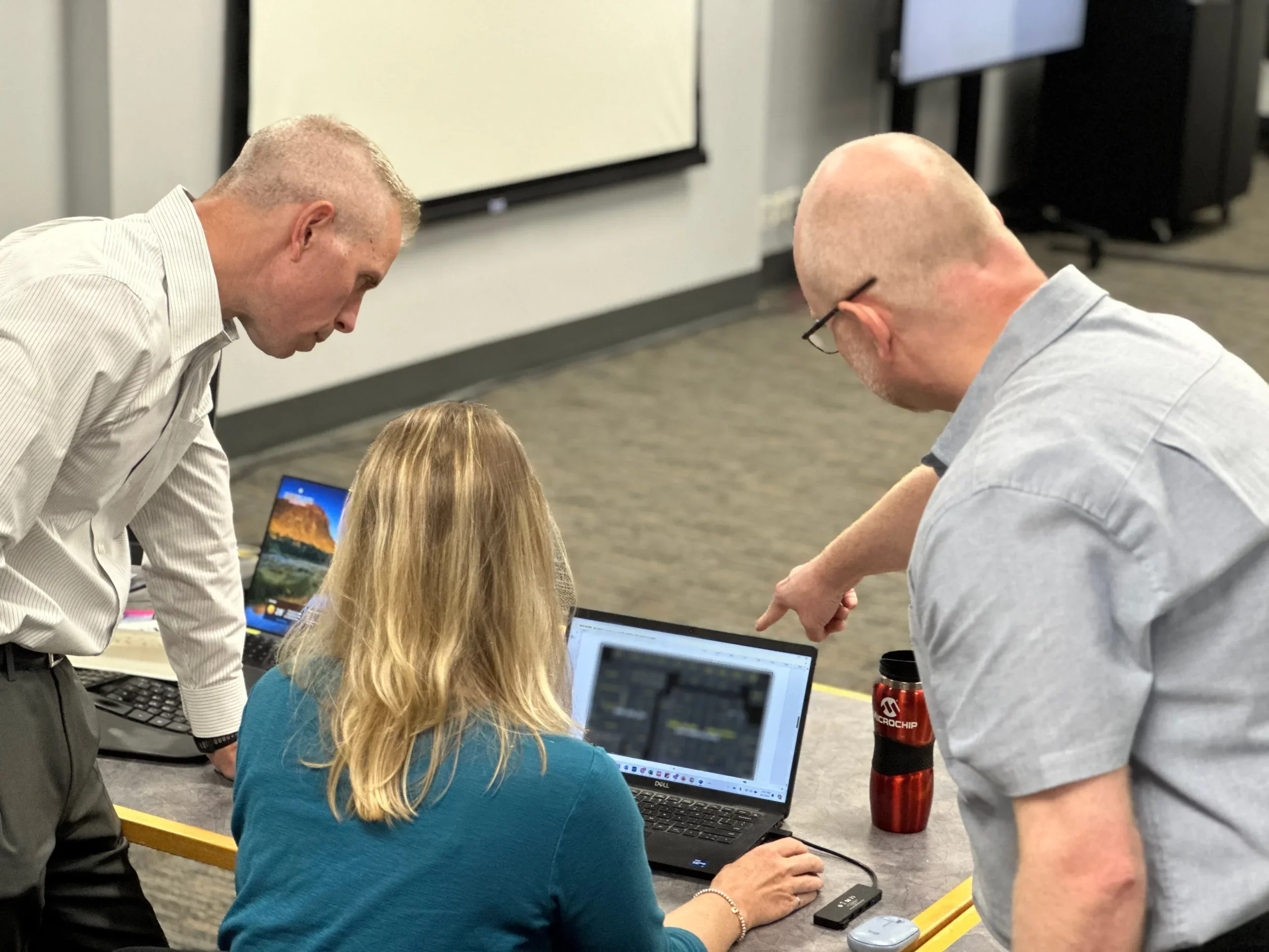 Microchip engineers reviewing the High Performance Spaceflight Computer (HPSC) floor plan. 