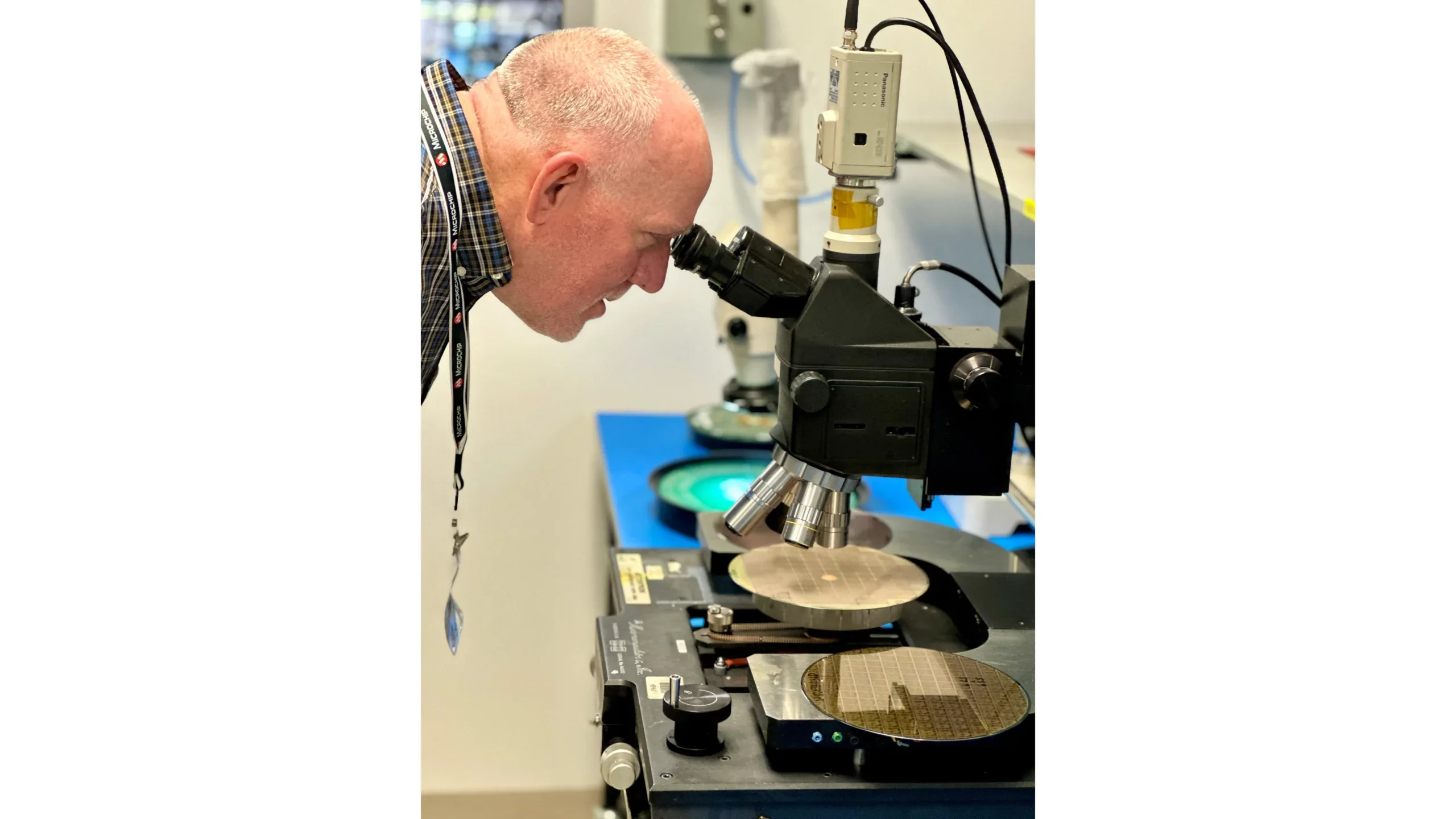 A NASA engineer inspecting a semiconductor wafer at Microchip’s test facility, a critical step in ensuring the reliability and performance of electronic devices that can withstand extreme environments such as those encountered in space. 
