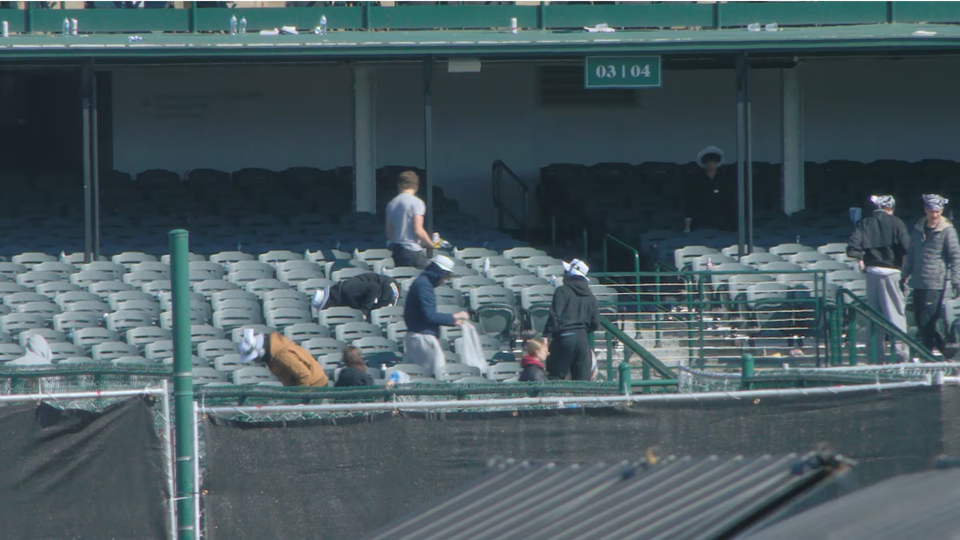 Students from local high schools help out with the cleanup effort at Churchill Downs after the Kentucky Derby.