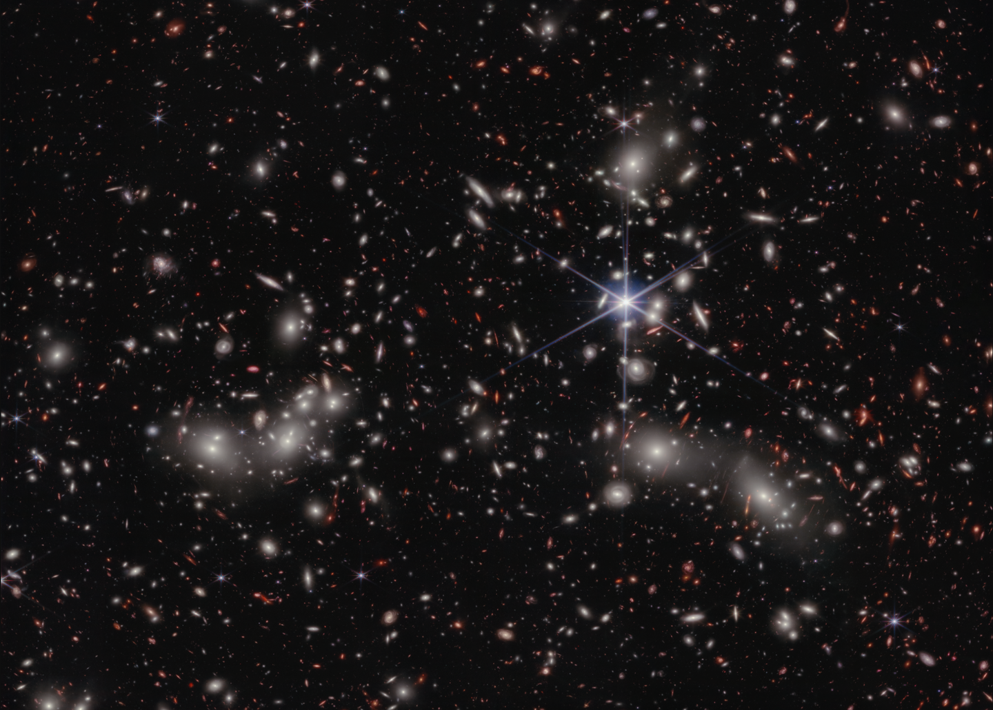 Located behind Pandora's Cluster in the constellation Sculptor, Abell 2744-QSO1 is triply imaged by the cluster's gravity.