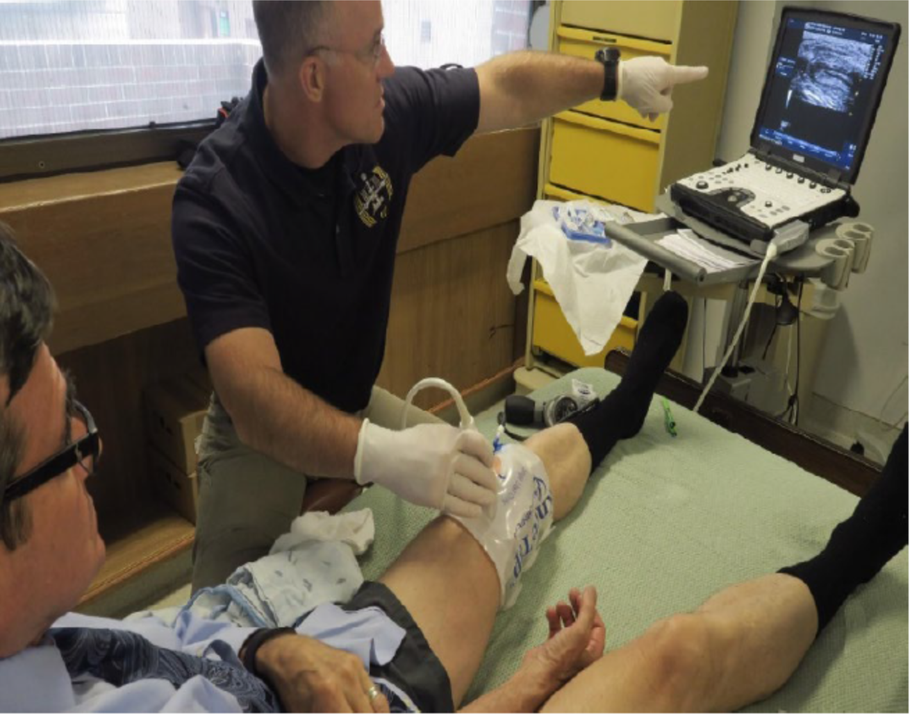 Image below, NASA/ JSC Flight Surgeon Dr Rick Scheuring performing knee ultrasound examination with KneeTapTM external pneumatic compressive device on RM at National Jewish Health Denver CO.