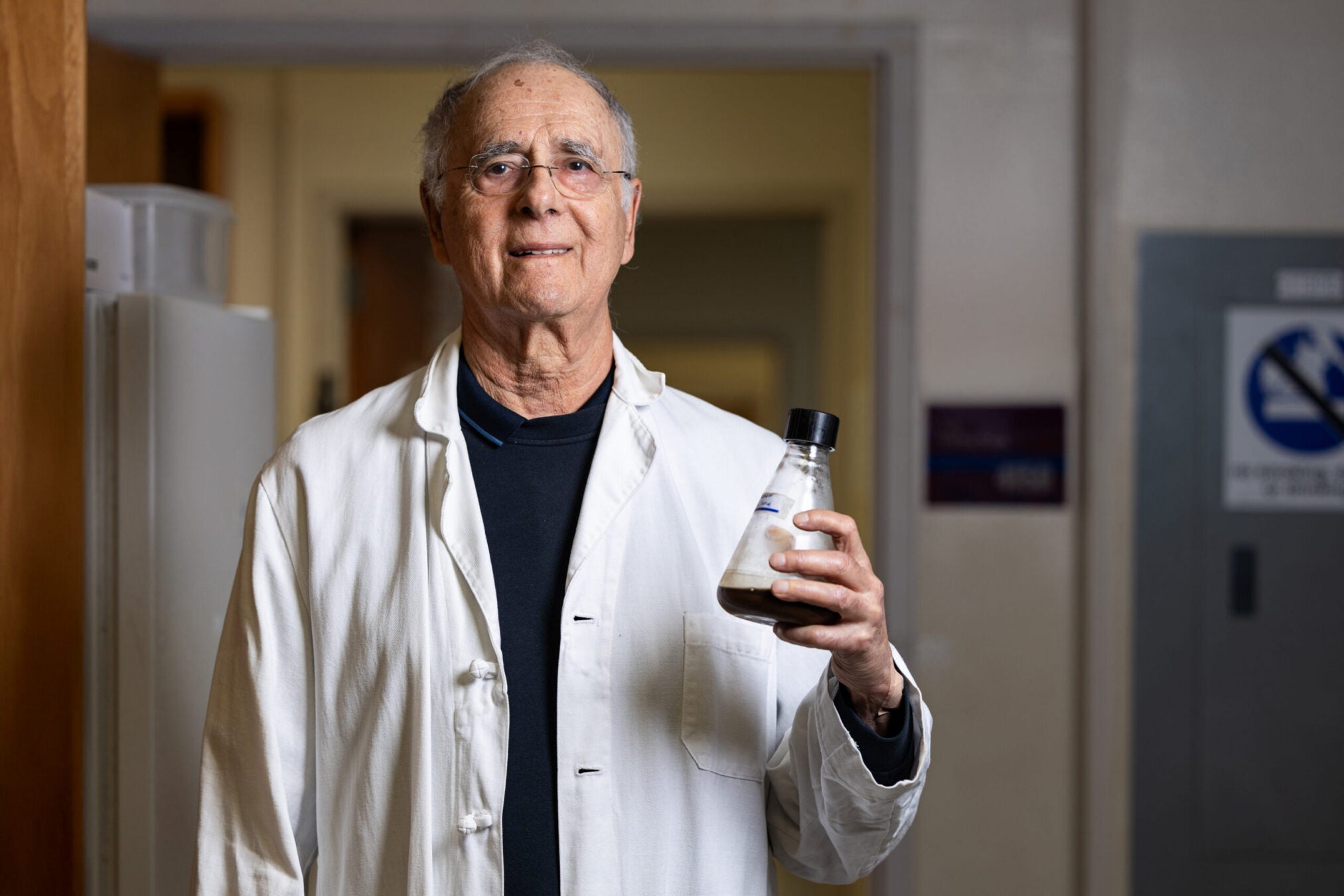 Dr. Stephen Safe holds a flask of coffee in his laboratory, part of research examining how compounds in coffee may influence human health.