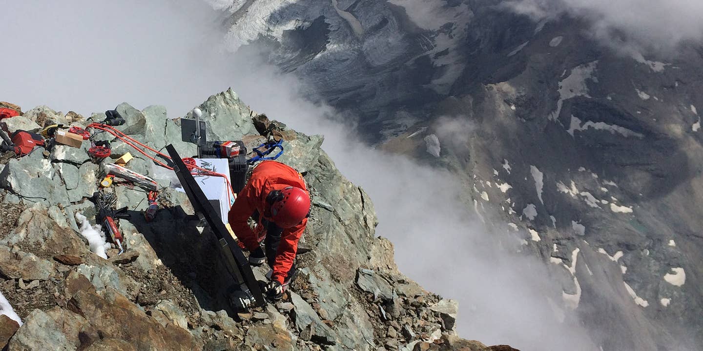 Science in lofty heights: Samuel Weber installs a seismometer and a solar panel on the summit of the Matterhorn.
