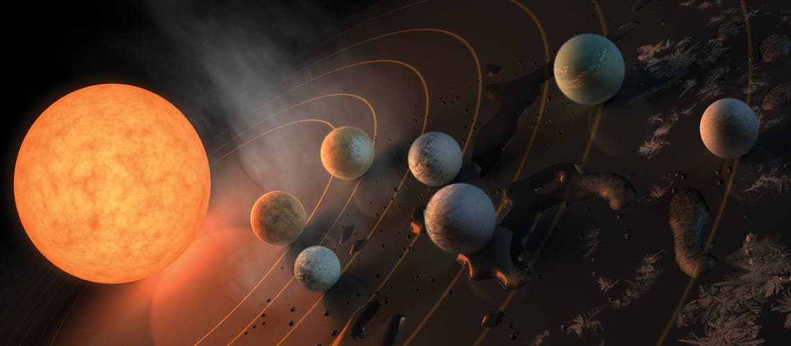 This artist’s impression displays TRAPPIST-1 and its planets reflected in a surface. The potential for water on each of the worlds is also represented by the frost, water pools, and steam surrounding the scene.