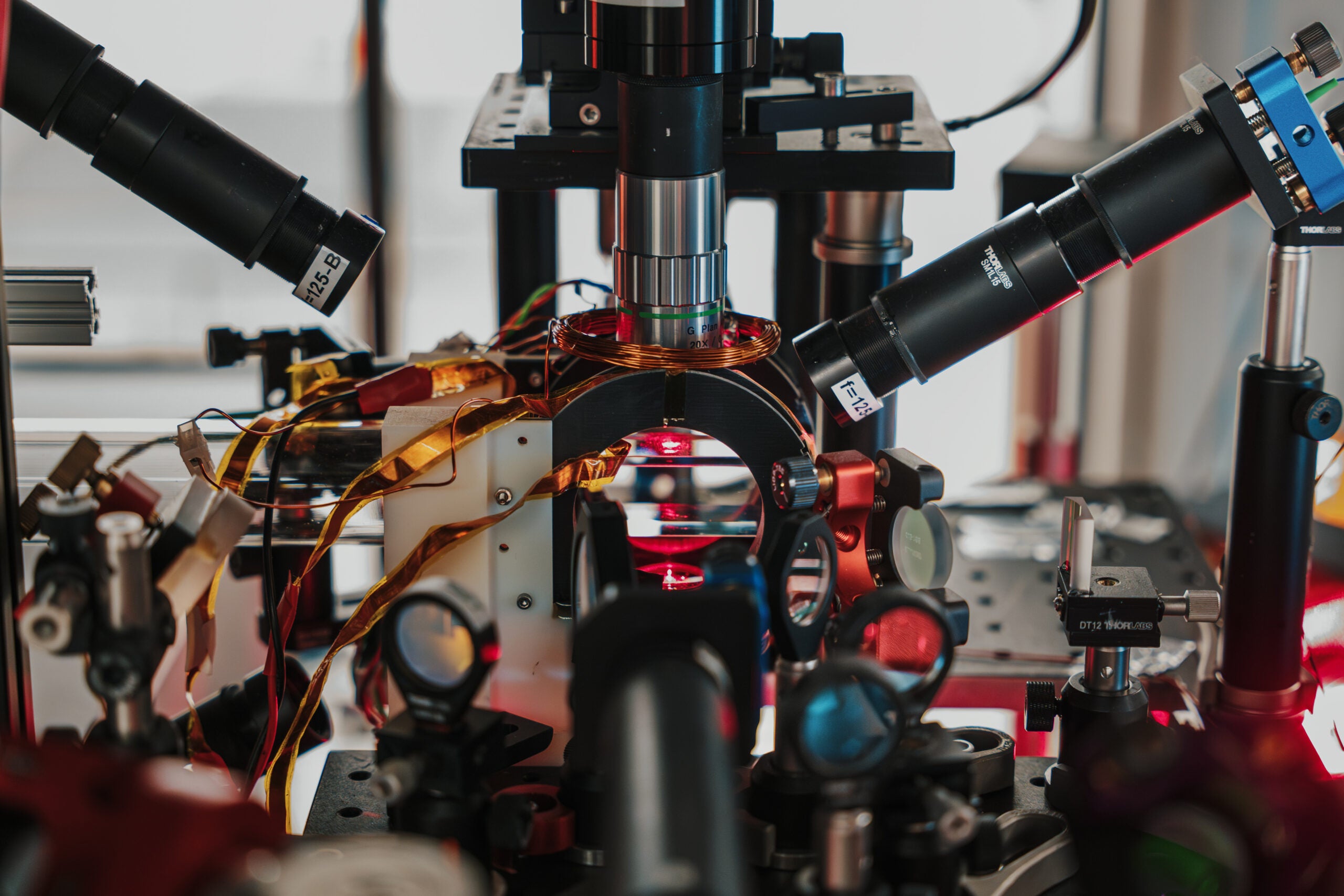The 'cloud' inside the glass cell is a magneto-optical trap of rubidium atoms at a temperature of ~0.0001 degrees above absolute zero. It is only the first step to "build" the mini-universe.  