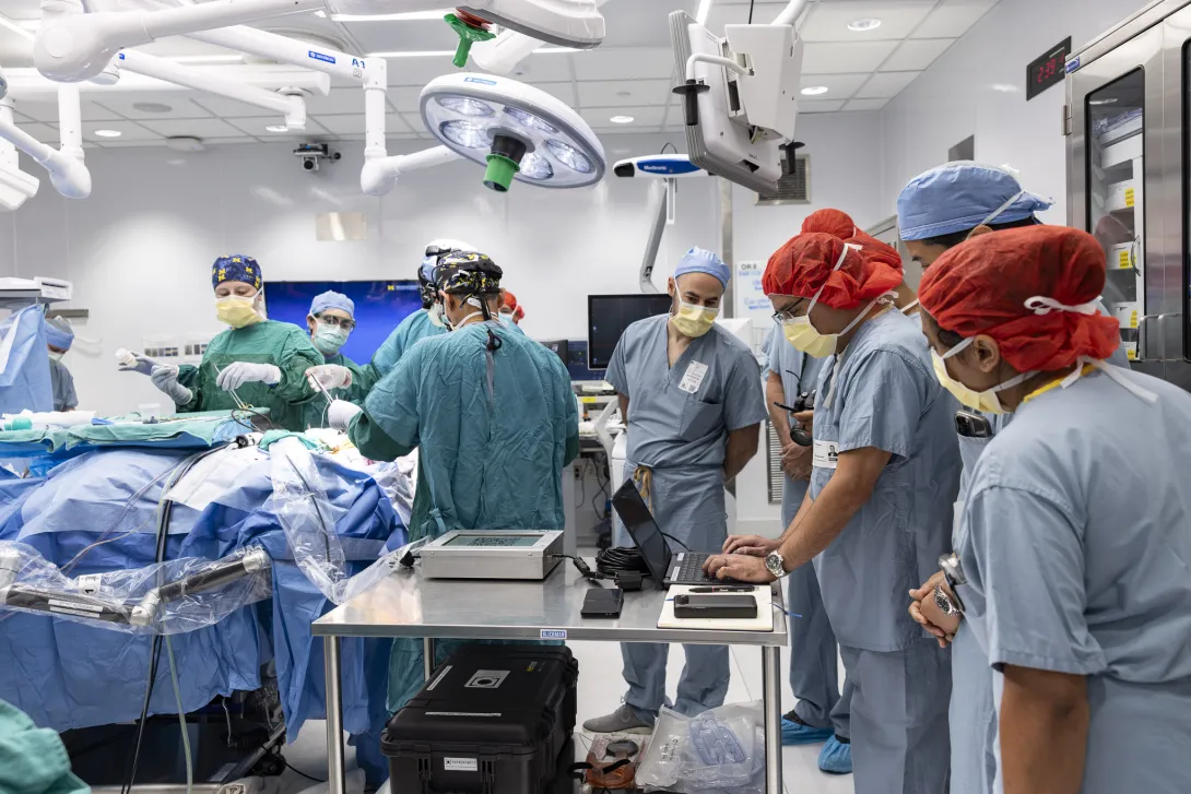Dr. Kurtis Nishimura of Paradromics collecting intraoperative neural data while the clinical team finishes the operation.