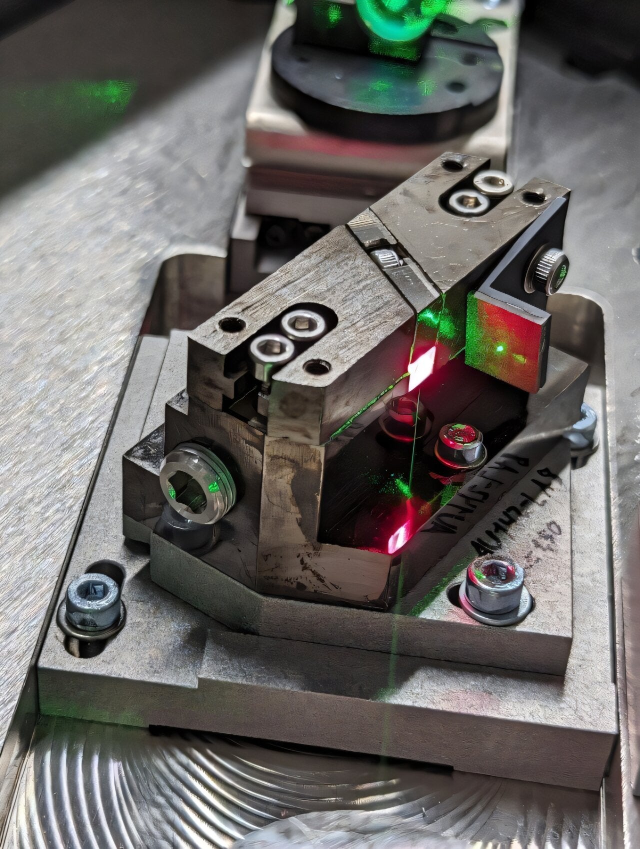 A key challenge in building large-scale quantum sensors is producing high-power laser light with extreme frequency precision. This image shows a titanium-sapphire crystal resonating inside an optical cavity, generating light used to manipulate the quantum states of atoms. The red laser is among the purest light ever created, remaining a single shade of red to roughly the fifteenth decimal place.
