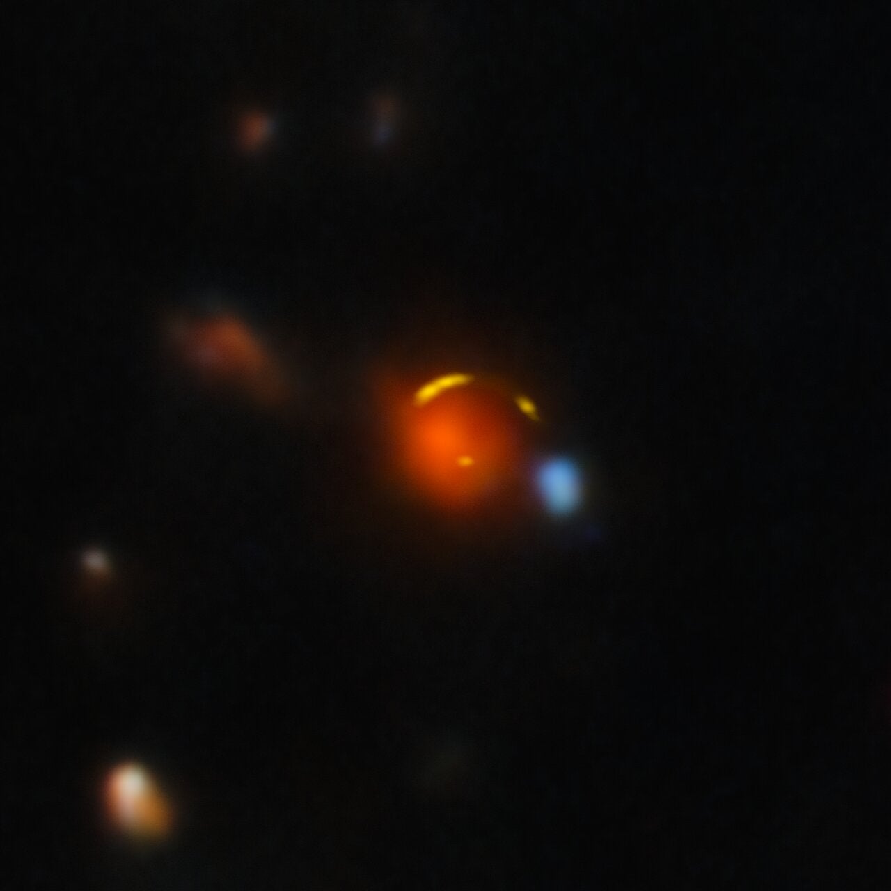 This image shows the gravitationally lensed galaxy nicknamed "Shadow Blaster," which astronomers have identified as the likely source of the high-energy neutrino event IC 210922A, detected by the IceCube Neutrino Observatory in 2021.