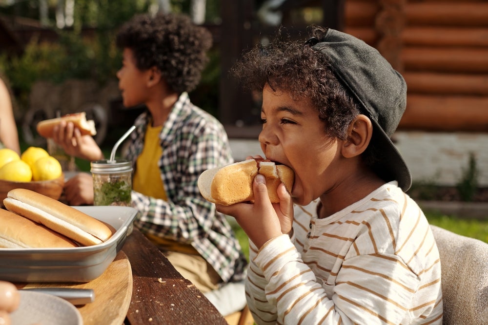 Because children's bodies and eating habits are still developing, early and frequent exposure to red and processed meats — like hot dogs — can cause lasting harm.