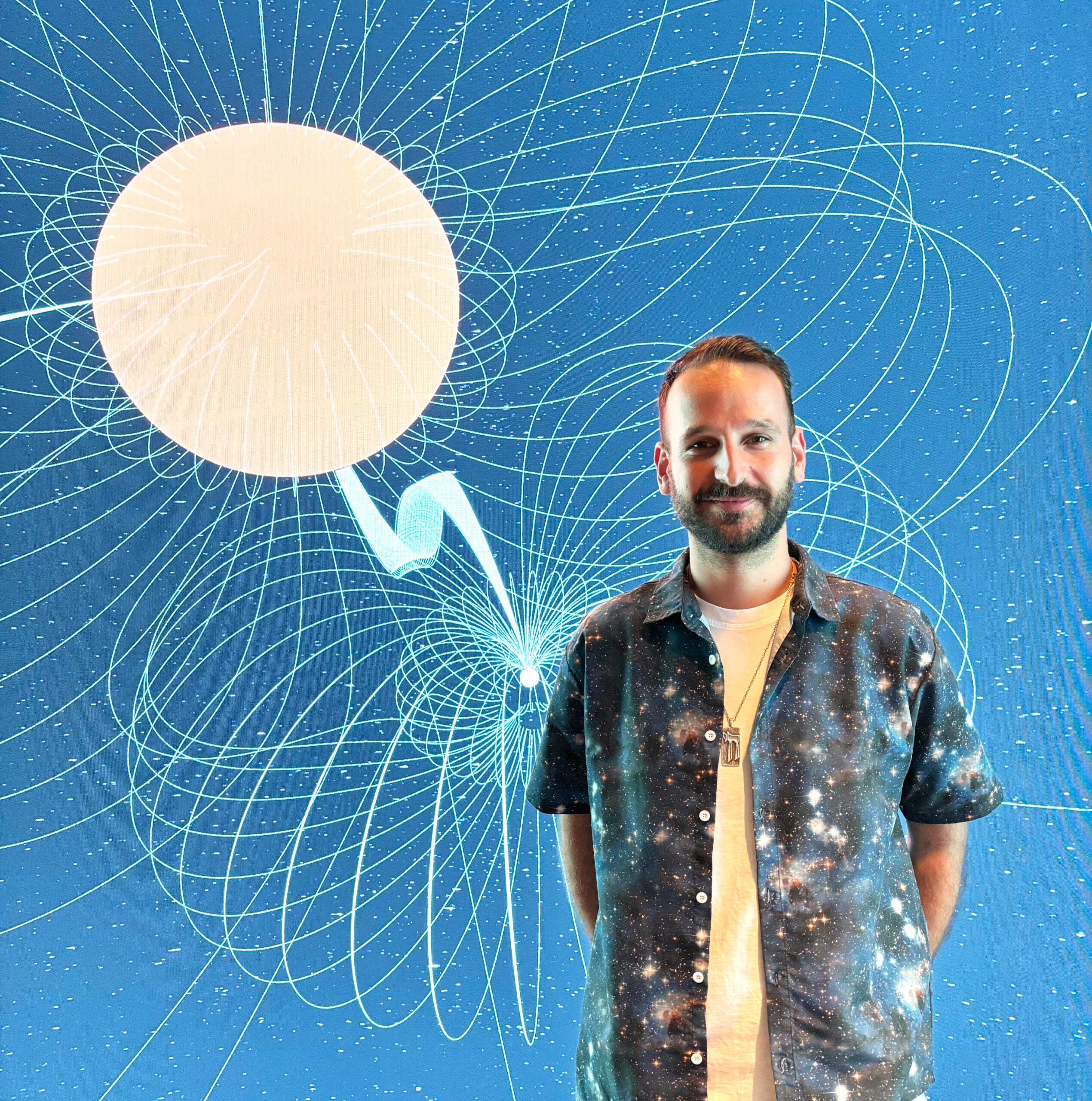 Lead author Kovi Rose from the School of Physics at the University of Sydney, stands in front of an image visualization of the white dwarf binary ASKAP J1745-5051. 