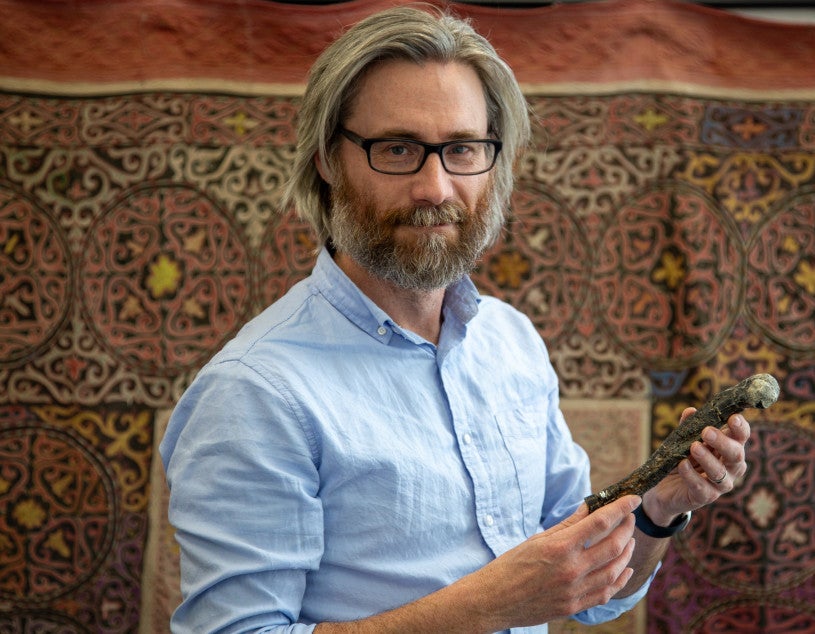 Dr. Alan Turner (Stony Brook University) holding the femur of Labrujasuchus expectatus.