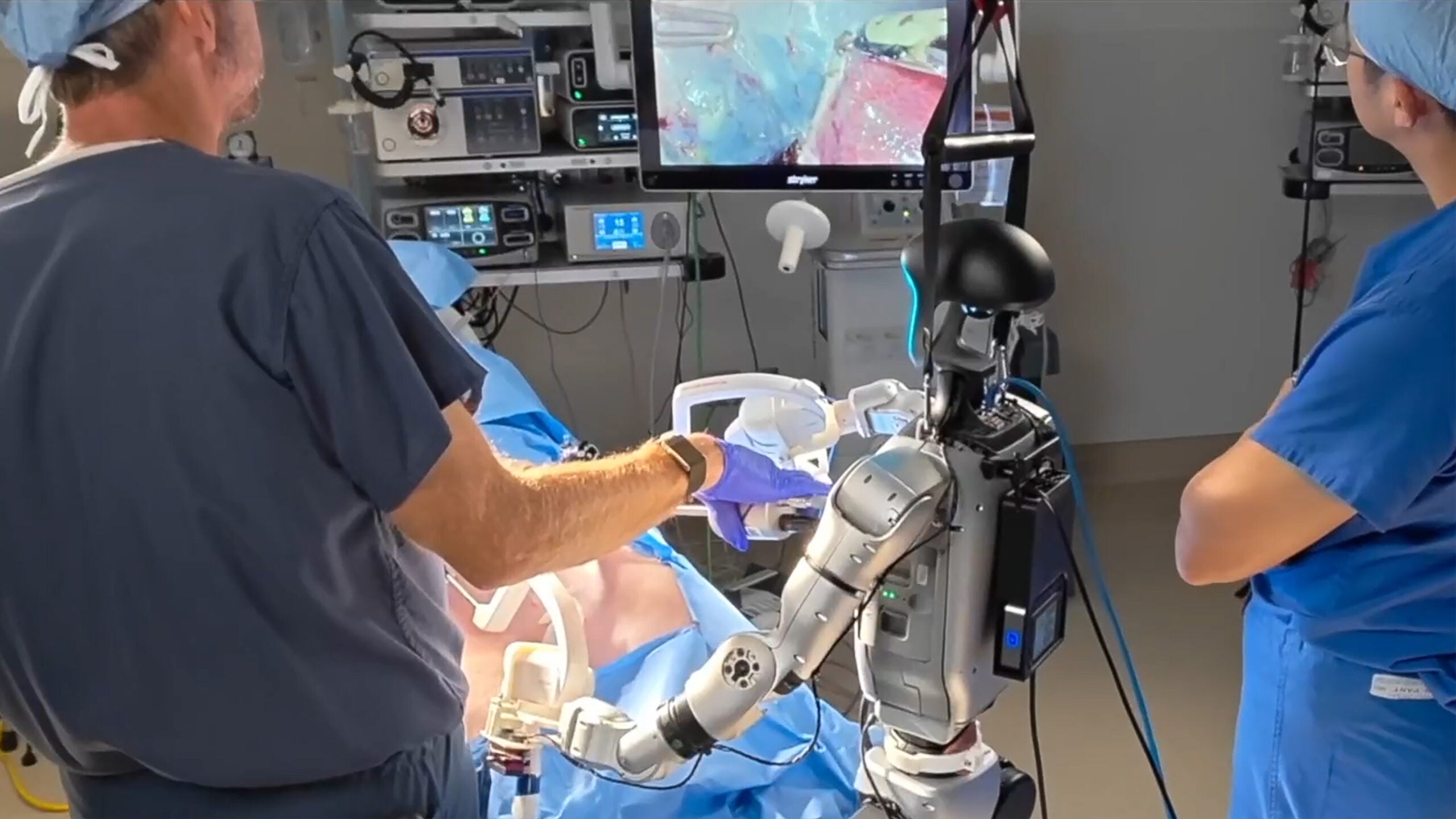 Physician and teleoperated humanoid robot working together.
