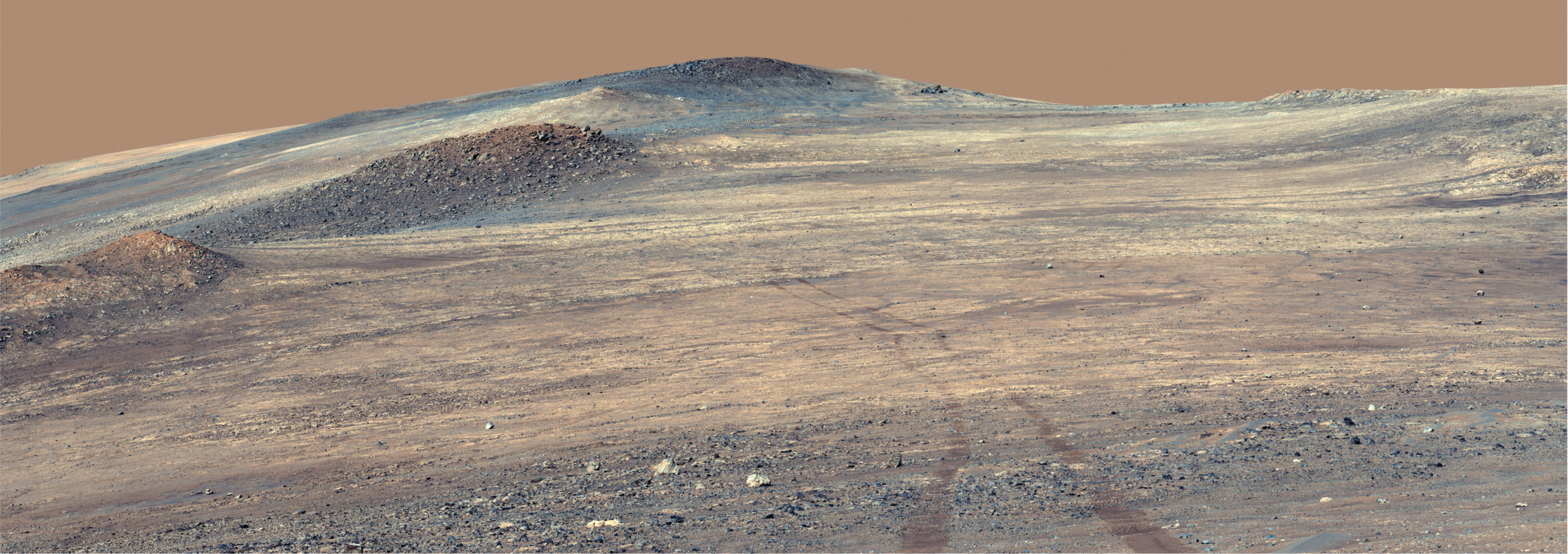 NASA’s Perseverance rover captured its own tracks descending from the rim of Jezero Crater. The bright-colored rocks running from middle left to middle right of the image, a formation dubbed the “Broom Point member,” are likely more than 3.9 billion years old, making them among the oldest terrain ever examined by a Mars rover.