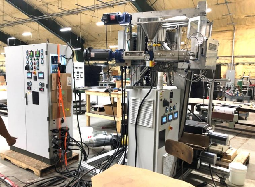 A lab-scale twin-screw Xplore system including (1) micro-compounder, (2) cooling bath, (3) filament line, and (4) pelletizer.