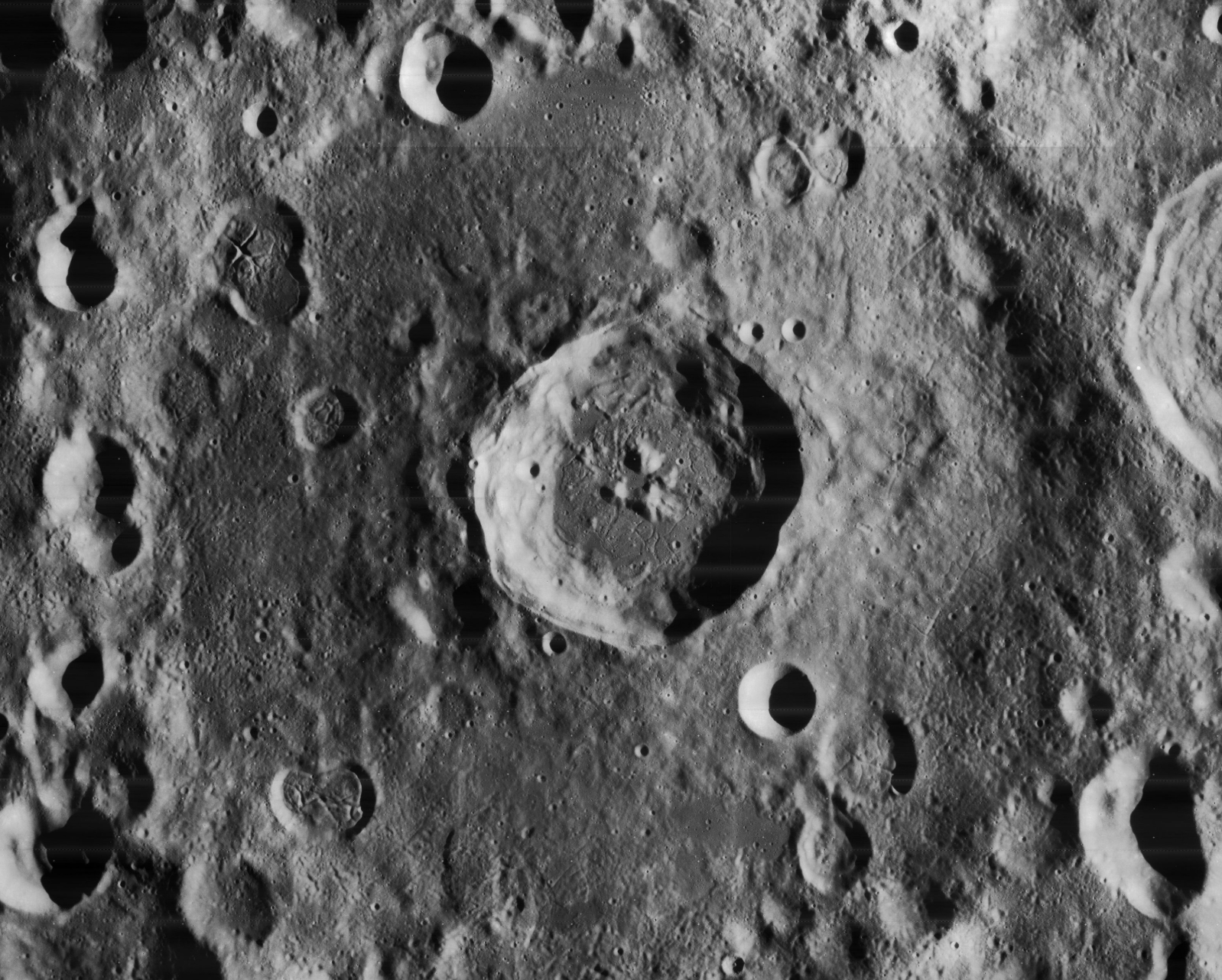 The larger, eroded crater filling the frame is Einstein. The smaller crater at center is Einstein A.