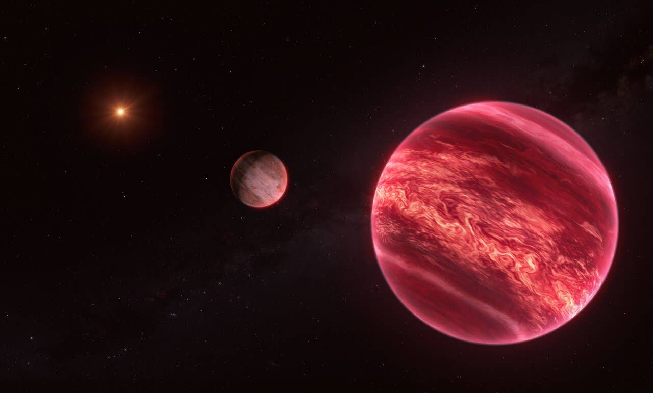 This illustration shows the system around the star CD-35 2722, with the newly found moon-like object at the centre. The star –– the point source to the left –– has about half the mass of our Sun, and it is orbited by a brown dwarf, the reddish-brown object seen here in the foreground (right).