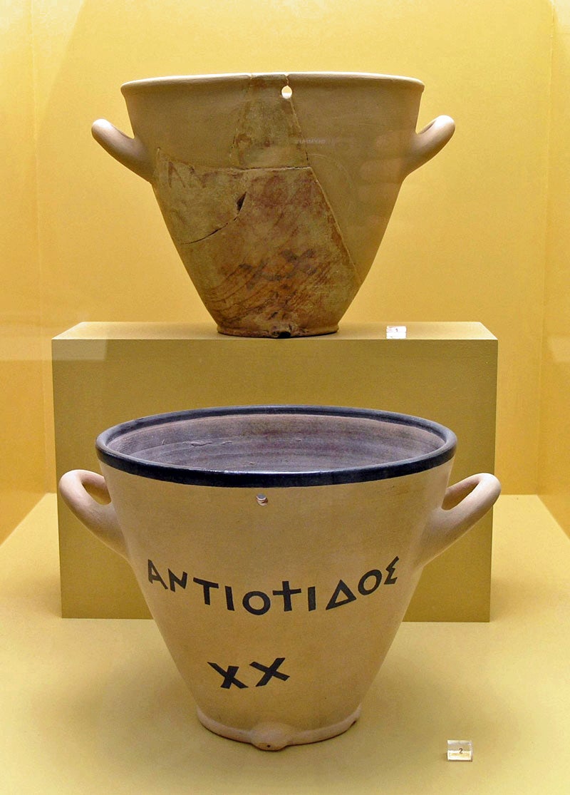 Two outflow water clocks from the Ancient Agora Museum in Athens. The top is an original from the late 5th century BC. The bottom is a reconstruction of a clay original.