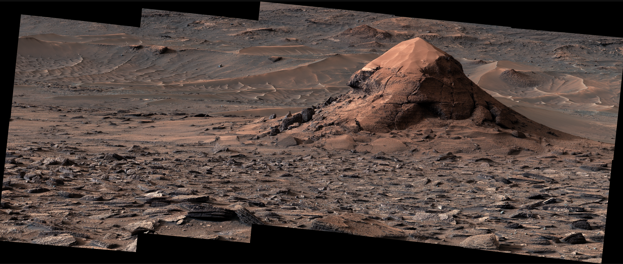 NASA’s Curiosity Mars rover captured this sand-capped butte, nicknamed “Miraflores,” estimated to be about 20 feet (6 meters) tall, on June 11, 2026. The surrounding area includes an expanse of terrain covered in surface features called polygons.