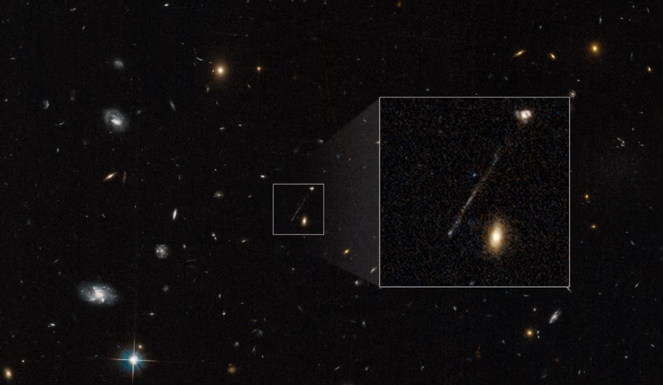 Scientists initially blamed the streak on a Hubble imaging glitch. Follow-up observations instead revealed a 200,000-light-year trail of young blue stars stretching toward the galaxy at upper right.