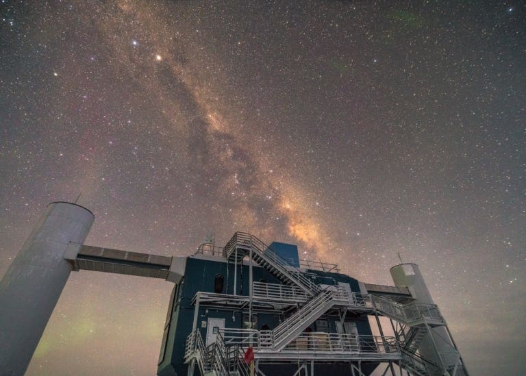 IceCube at the South pole with the Milky Way in the background.
