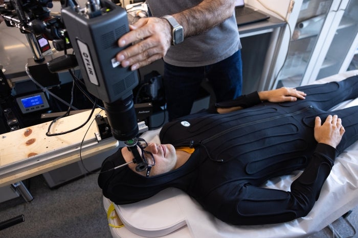 Konrad Rykaczewski wears the thermal suit used to raise body temperature and induce sweating in his lab.
