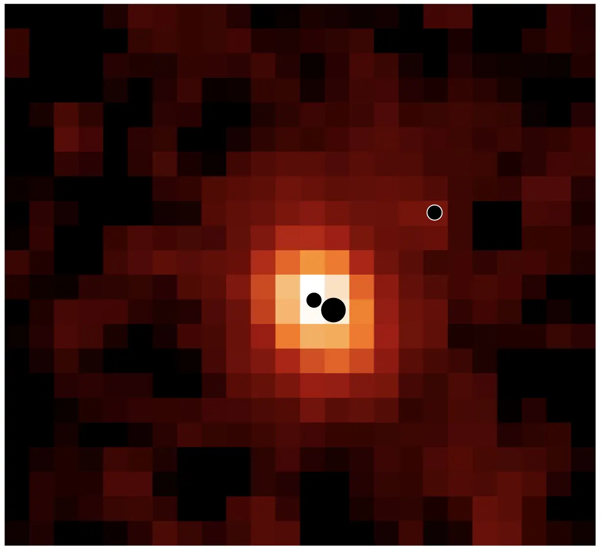 Map of the distant galaxy J0148-4214 in ionised hydrogen (Hα). The locations of the three massive black holes are indicated by black circles (not to scale). The most massive and least massive black holes are located in the galaxy centre; a third black hole is located in the galaxy outskirts.