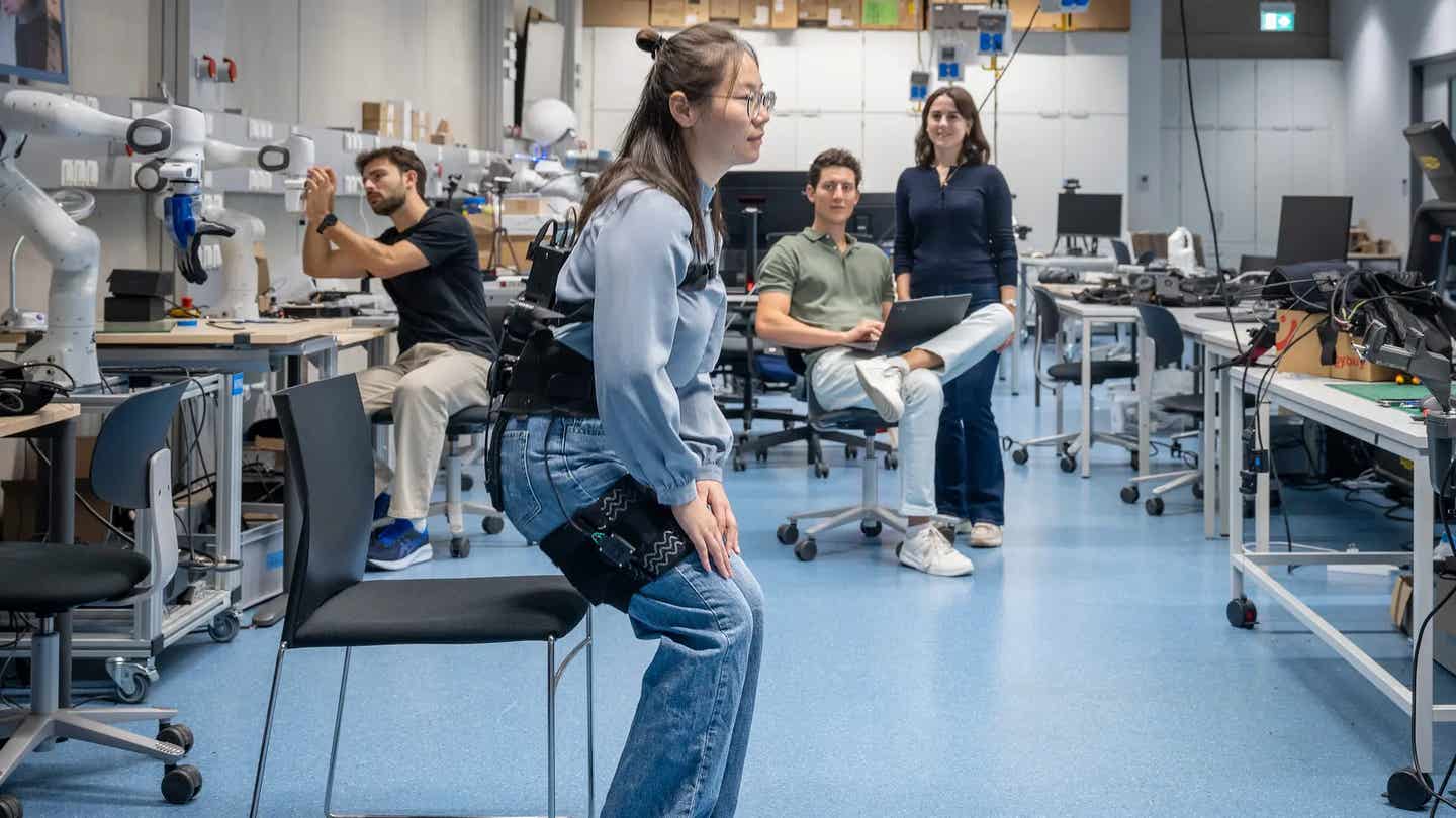 Dr Xiaohui Zhang from the Chair of Intelligent Bio-Robotic Systems at TUM demonstrates her exoskeleton, which helps older people with hip problems to stand up.