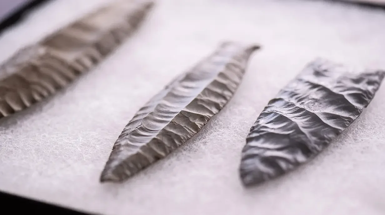 On the right is a replica of a projectile point from the Clovis people, who were among the first people to live in the Tennessee River Valley region. On the left are two spear points from the Cumberland people, who inhabited the region after the Clovis.