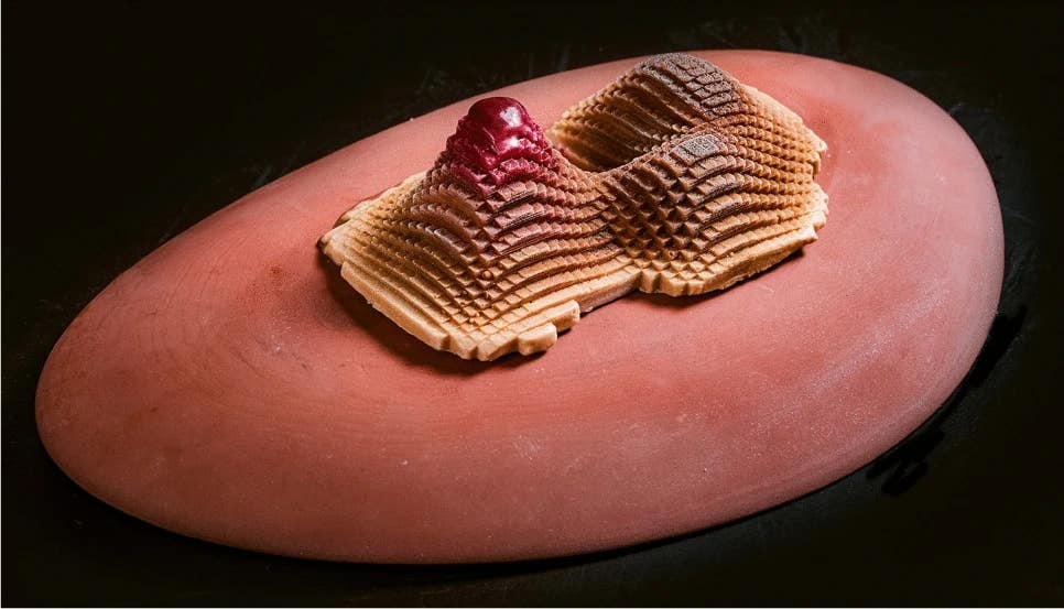 Pixel Cake. A layered confection composed of modular edible units arranged through computational design and assembled by hand. The work illustrates how artistic meaning can emerge through the interplay of digital organization, material transformation, and embodied experience, rather than residing solely in the finished object.