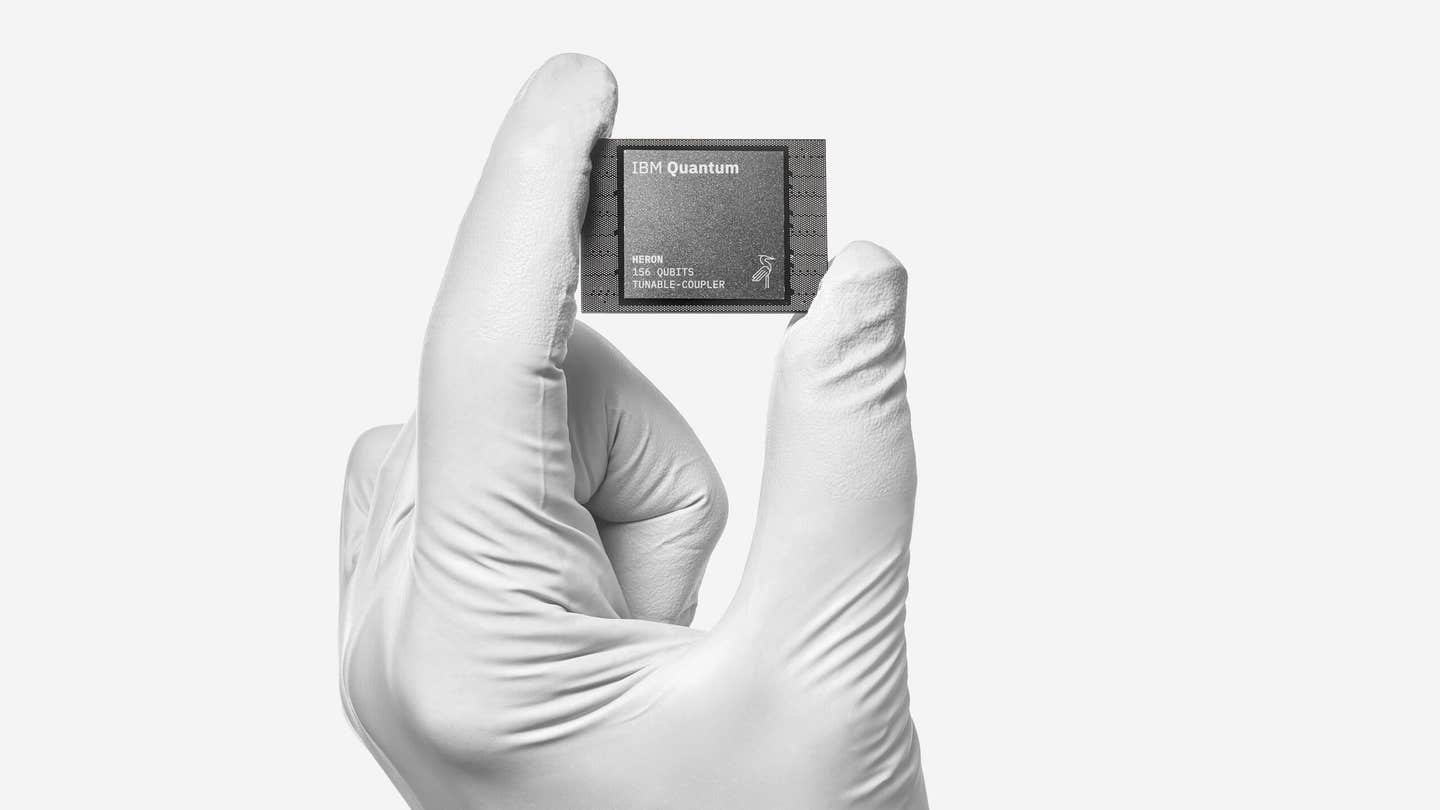 IBM Quantum Heron quantum processing unit in hand. Repeated measurements and resets controlled chaos across 100 qubits, testing hardware capabilities relevant to future error correction.